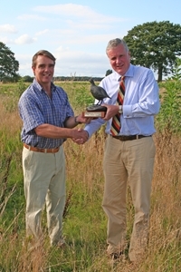 Stuart Stark of Fridlington Farms (left) receives the Yorkshire Grey Partridge Trophy from Paul Ainscough of sponsor’s Savills