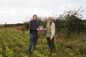 John Bowman of Natural England (left) presenting the trophy to Martin Baird of Red Hall Farm (right)
