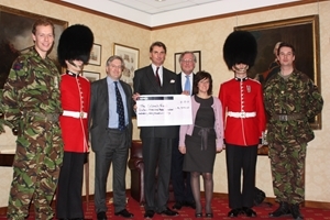 Over £16,000 was raised for The Colonel's Fund at a previous talk in 2011. Pictured: Major Grant Baker receives the cheque from Edward Hay and Mel Dellow of the GWCT