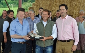 Mr John Phillips (centre) from Fairford in Gloucestershire, who has gone that extra mile for wildlife on his organic farm is pictured receiving his silver Grey Partridge Trophy from former winner of the trophy Mr Richard Benyon MP (left) and Mark Tuffnell (right) sponsor of the trophy and Chairman of the Cotswold Grey Partridge Group