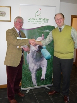 Alex Towns (left) at his retiral presentation with Dr Adam Smith, GWCT Director Scotland