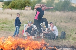 Bev Jacobs, representing GWCT Berkshire, jumps over fire as part of the gruelling 5km Spartan race
