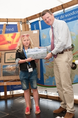 9 year old Eloise Rux-Burton from Chipping Norton, Oxford with environment minister Mr Richard Benyon MP was a runner-up in the under-16 category for her delightful image of a Christmas in Wales