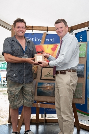 Martin Munn from Smallfield, Surrey was the winner in the adult category and is pictured with his winning bronze hare trophy, which was presented by environment minister, Richard Benyon MP