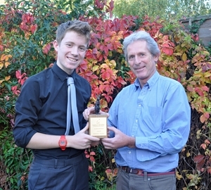 Christopher Page (left) receives the Julian Gardner Award 16-and-under trophy from GWCT's Peter Thompson