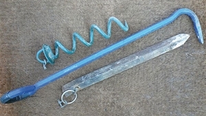 Two kinds of anchor: angle iron stake (below) and corkscrew (above). The man-hole cover lifter (centre) makes an excellent extraction tool for both anchors
