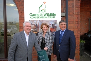 Celebrated Welsh rugby union player Gareth Edwards (left), with by GWCT chief executive Teresa Dent (centre) and GWCT Wales chairman Nick Williams (right), as he draws the winning ticket for the Fantastic Four raffle