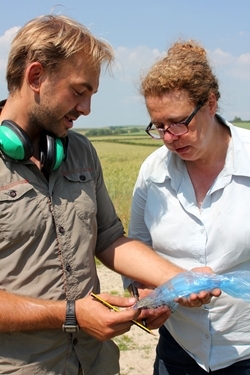 Ryan and Julie examine a sample